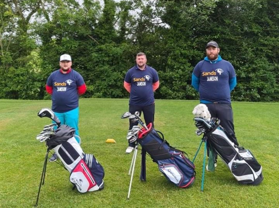 3 Golfers in sands T-shirts with their golf bags, ready to hit the course 