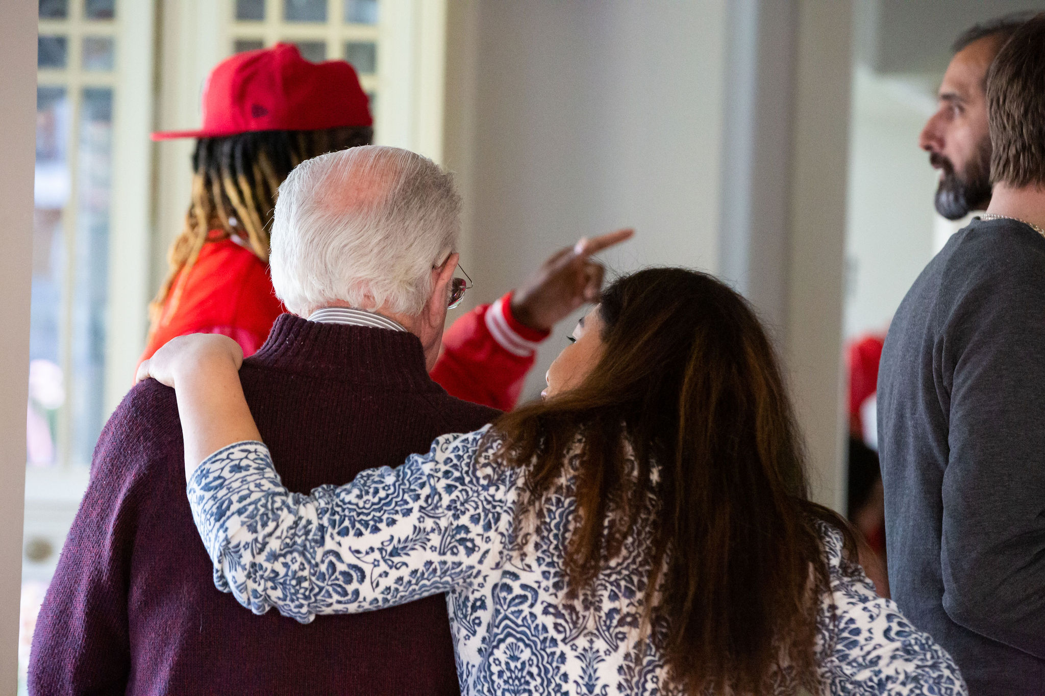 A lady with her arm wrapped around an older gentleman's back