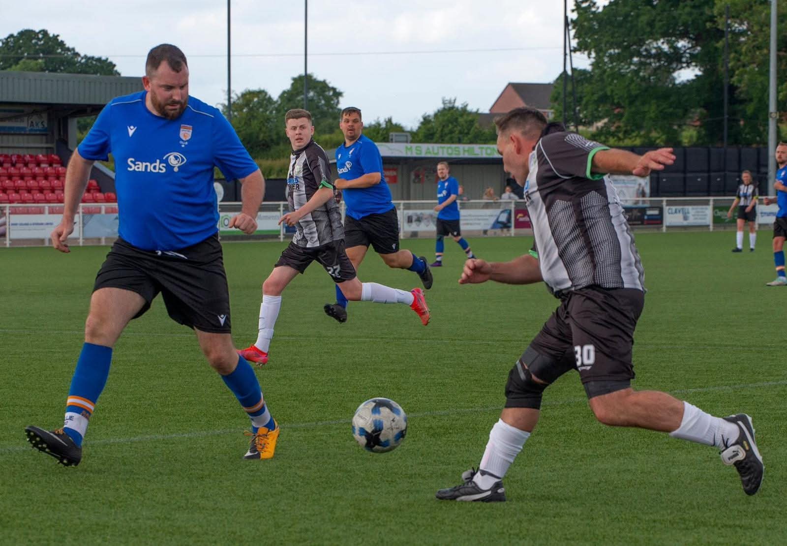 Rob McDonald and other men playing football in Sands United kit