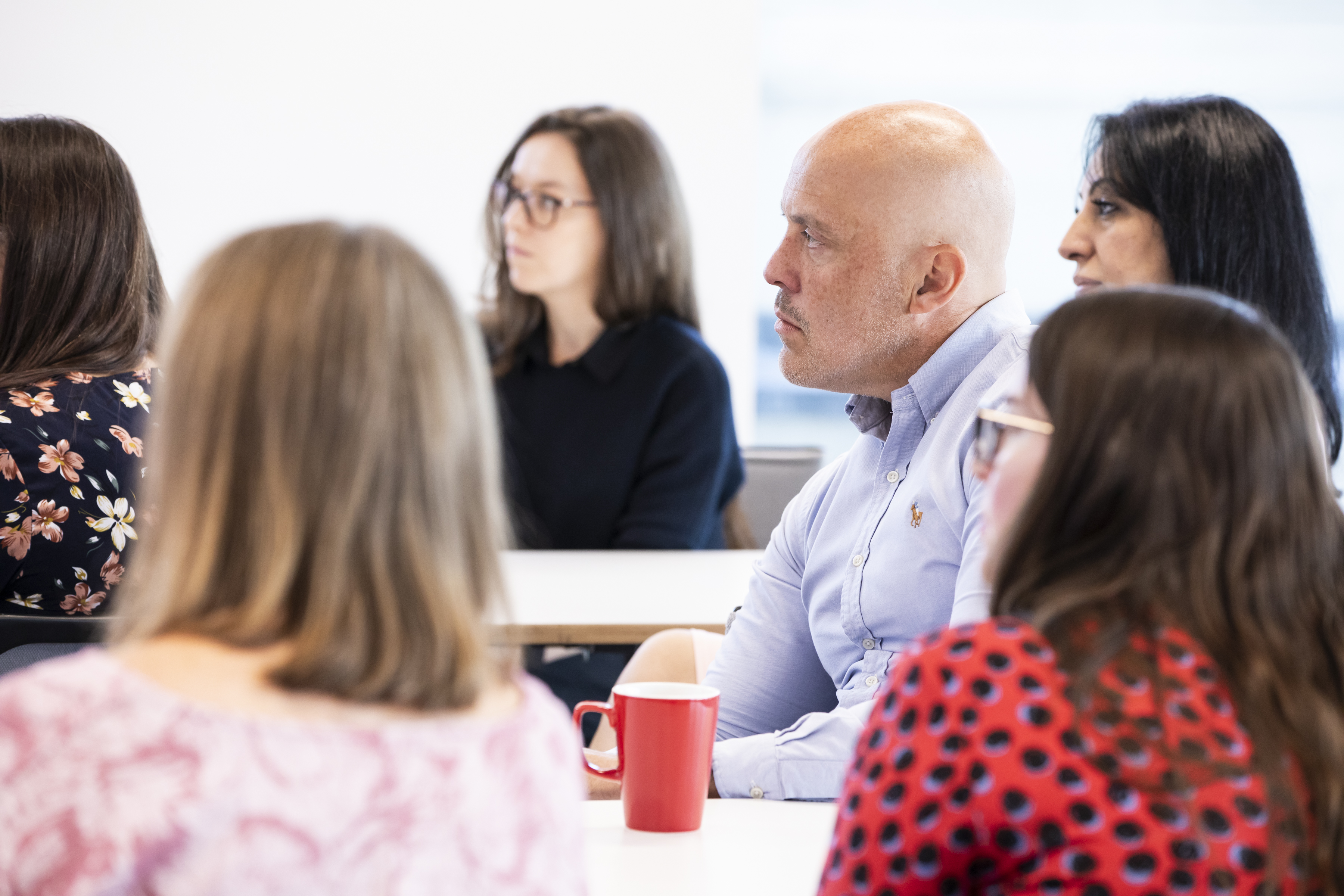 a group of colleagues sat around a table listening to a Bereavement in the Workplace training session