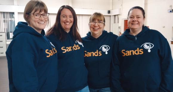 Sands Stockport volunteers in their Sands-branded hoodies.
