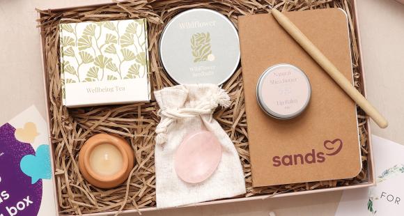 Sands Wellbeing Box with notebook, pen, comfort stone, wildflower seeds, tea, tea light and lip balm