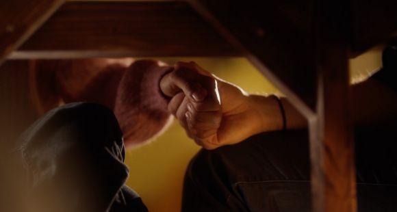 holding hands under a table