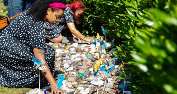Lady placing a stone at Sands Garden Day