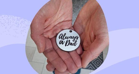Always a Dad token held in hands