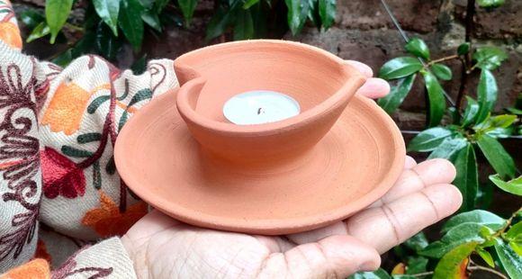 a lady holding a diya