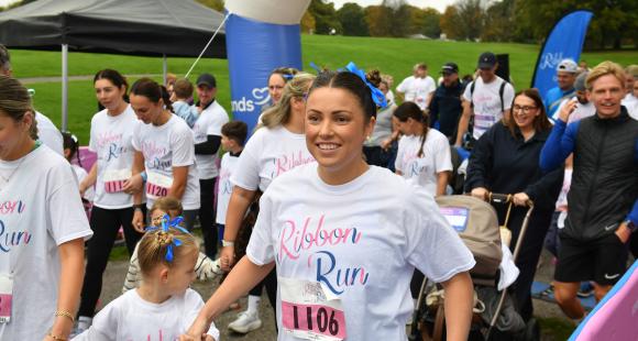 Families running over the line at Ribbon Run
