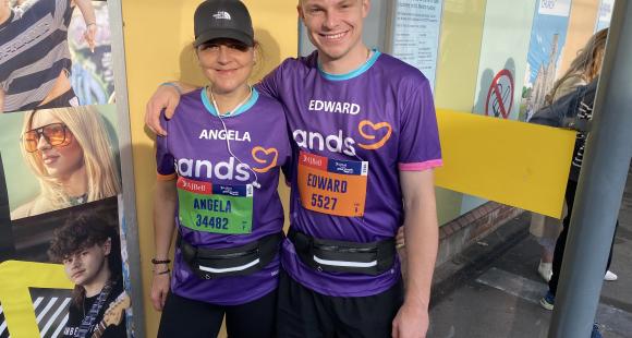 Man and Women with arms round each other wearing Sands t-shirts 