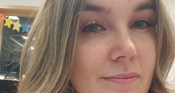 Lady with long dark hair smiling at the camera