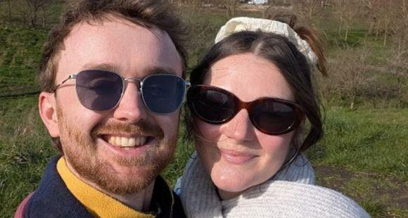 A man and a woman with sunglasses on smile at the camera after sharing her their baby boy was lost following a TFMR (Termination for Medical Reasons)
