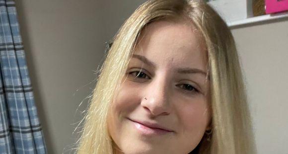 A lady with long blonde hair smiling at the camera