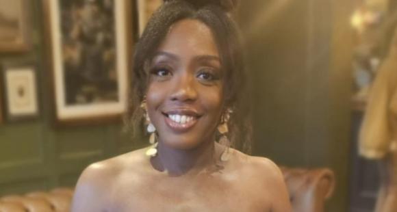 A lady smiles at the camera after sharing how she experienced twin loss.