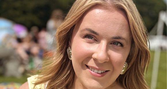 A lady with long blonde hair smiling at the camera