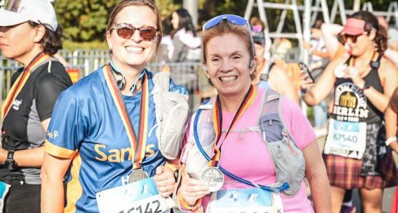 Two women runners smiling