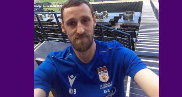 A man wearing a blue Sands United football shirt with the name Eva after he was told his baby daughter had no heartbeat.