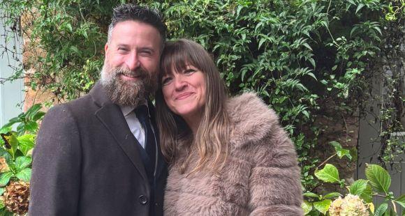 A couple smiling at the camera