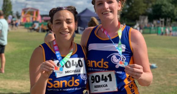 Two Sands runners holding medals