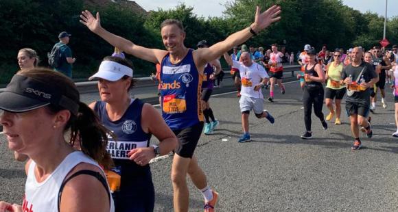 A Sands running with hands up in the air of celebration.