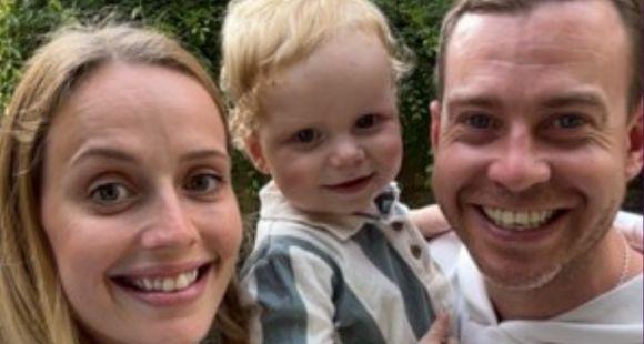 A lady with blonde hair, a little boy with blonde hair and a stripy shirt and a man with dark hair all smiling at the camera