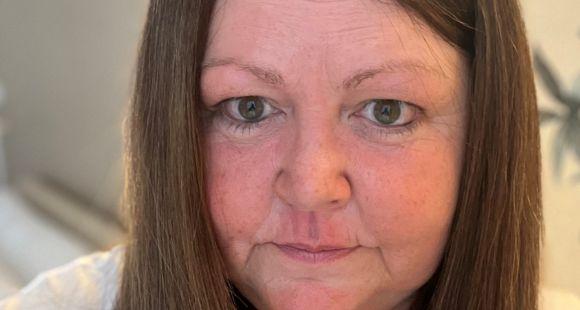 A lady with long brown hair looks at the camera after sharing how her daughter was a stillbirth.