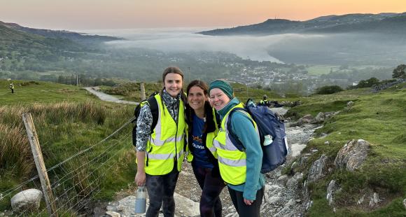 3 women in front of the view from below of Snowdon