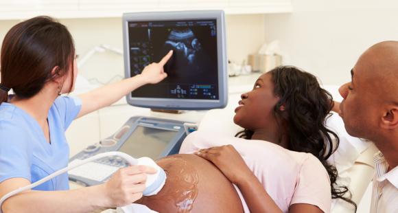 Black mother having sonogram with partner