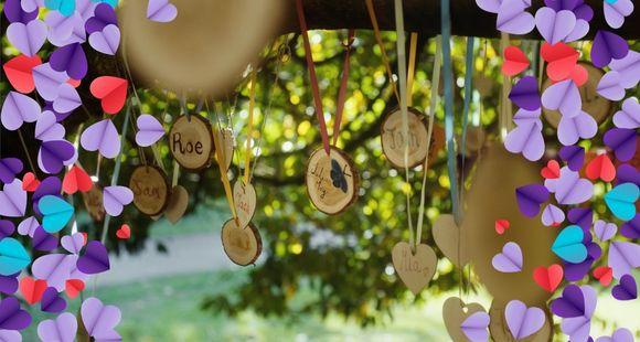 Baby names written on wooden tags are displayed on a tree