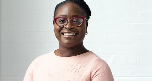 Photograph of Seyi looking at the camera and smiling