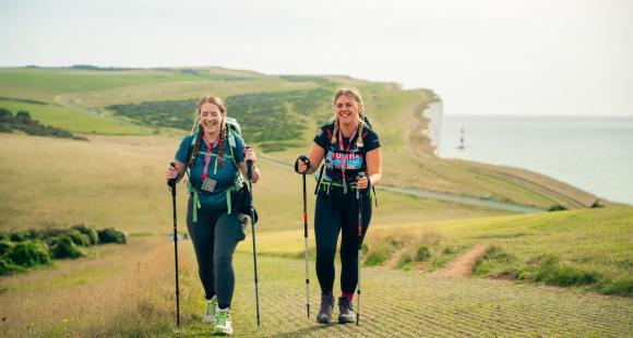 Two women walking on cliff