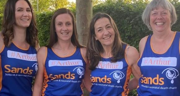 four female runners wearing sands running vests