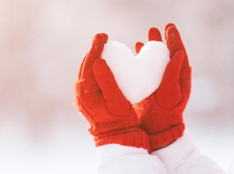 coping at christmas image with hands in red gloves holding a hear made out of snow