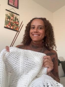 Image of knitter with blanket