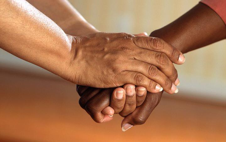 a close up shot of two people holding hands