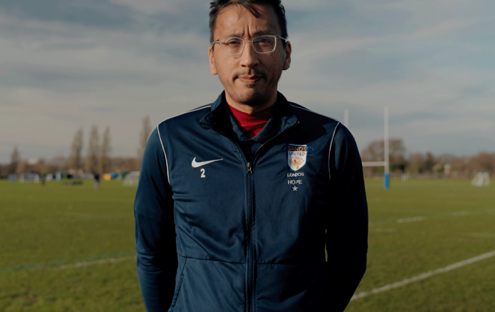 sands united manager holding up sands united flag
