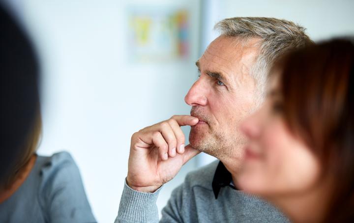 A man with grey hair looking up