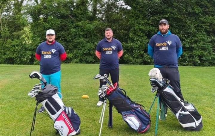 Image of 3 male golfers with Sands tshirts on and their golf bags, ready to golf