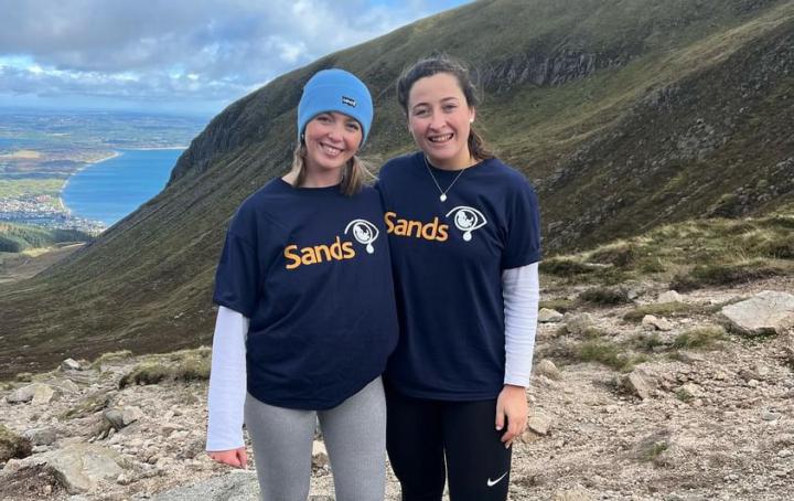 Sands fundraisers pose during a hike wearing charity t-shirts