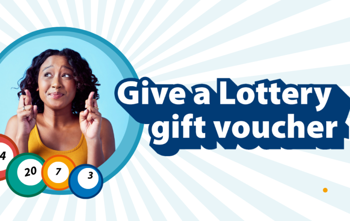 A lady looking hopeful, has her fingers crossed for luck. Text reads Give aLottery Gift Voucher