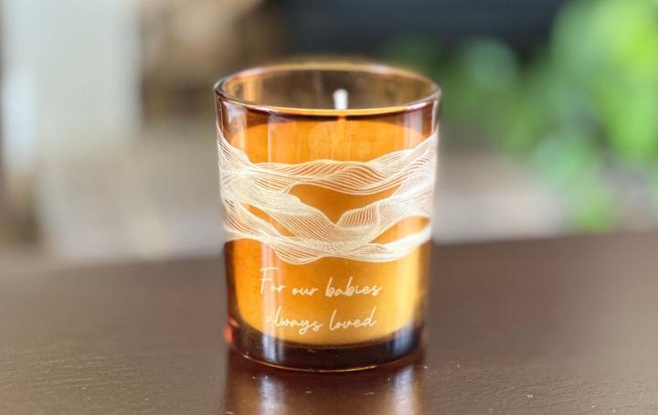 Next candle with text that reads 'For our babies. Always loved'