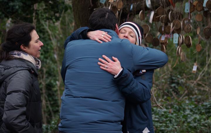 A man and a woman embraced in a hug