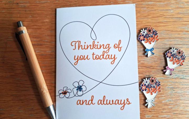 image of thinking of you card with 3 bouquet tokens next to it