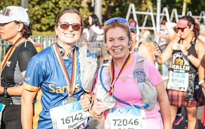 Two women runners smiling