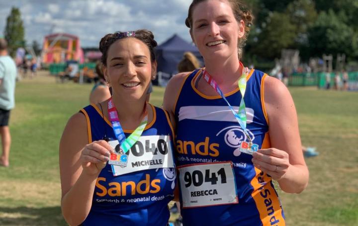 Two Sands runners holding medals