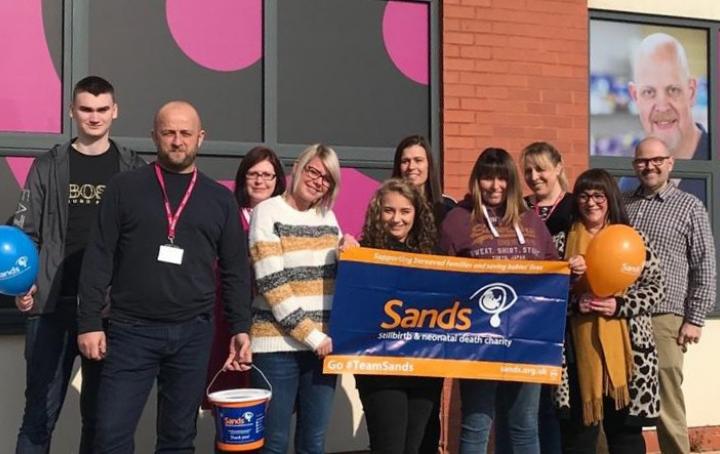 Payzone employees with Sands banner