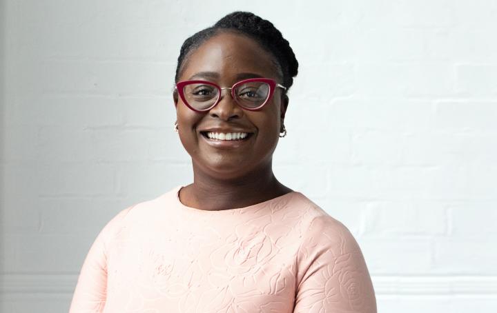 Photograph of Seyi looking at the camera and smiling