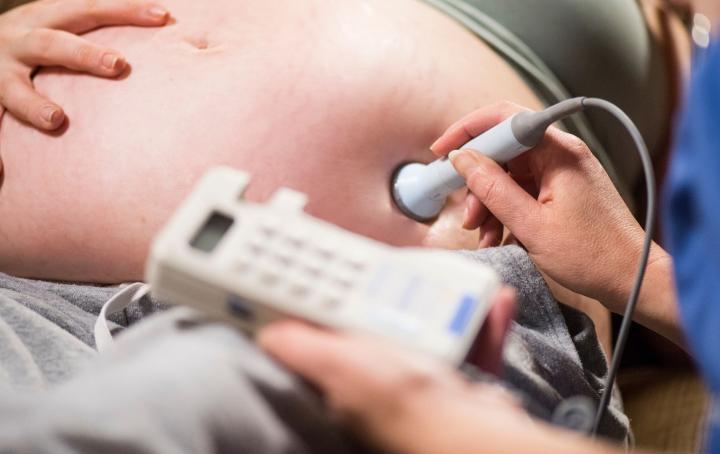 Pregnant woman is examined using a sonogram