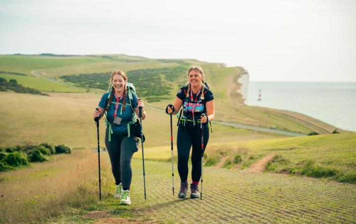 Two women walking on cliff